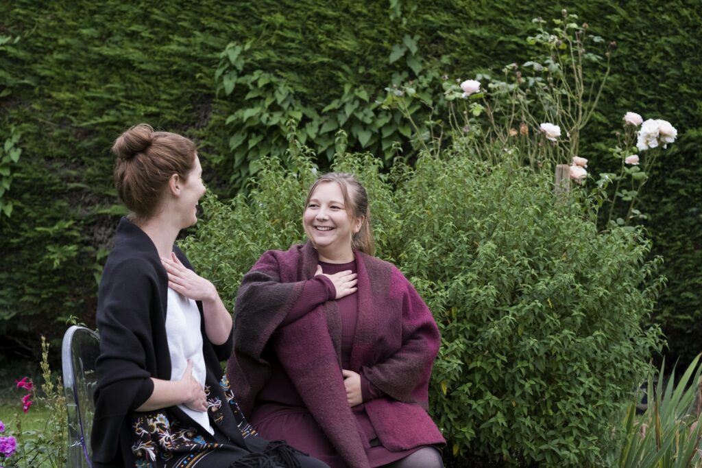 A woman and a therapist talking in a garden