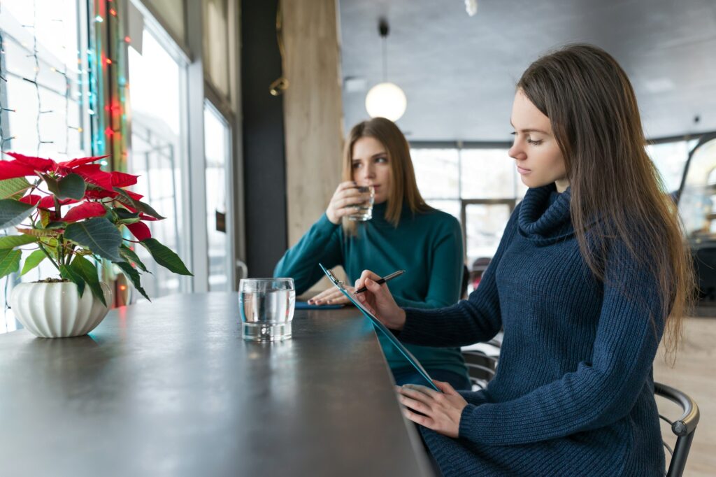 Woman psychologist counseling talking to a young girl