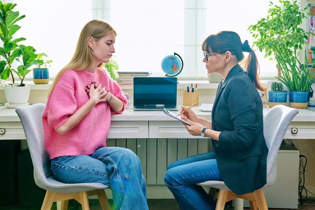 Young female at therapy meeting with psychotherapist